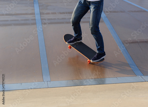 skateboarder legs skateboarding on skatepark ramp © lzf