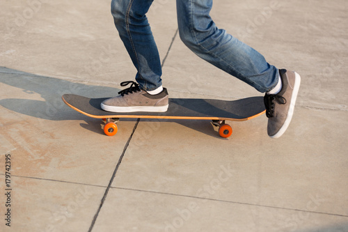 skateboarder legs skateboarding on skatepark