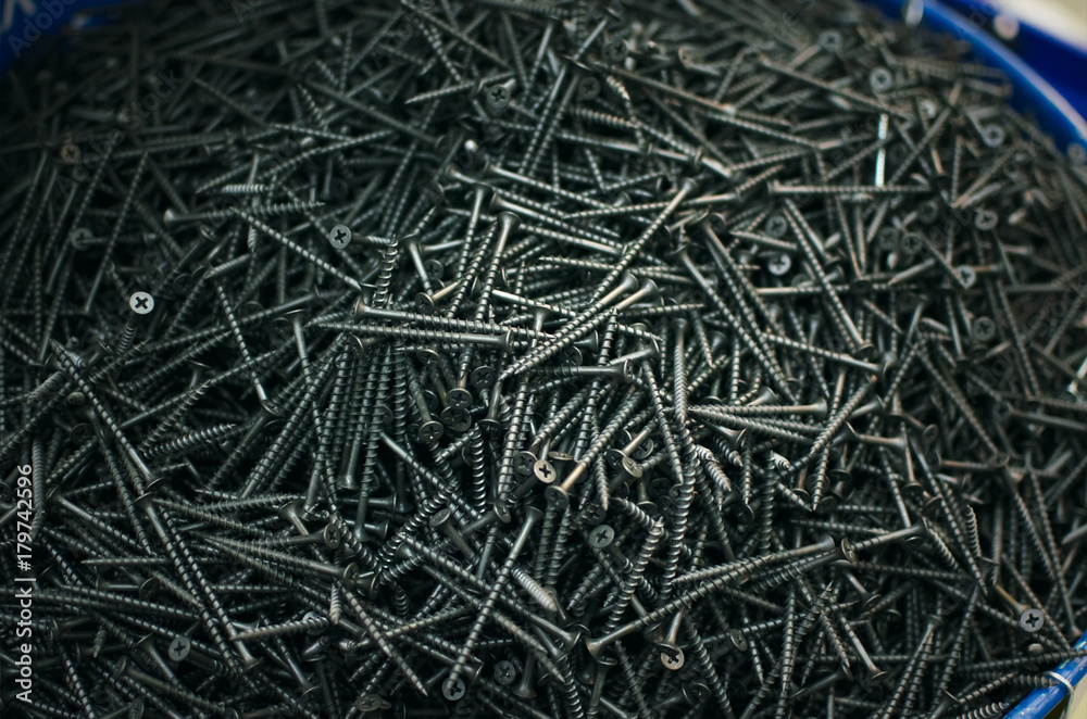 Screws in the barrel in the constructiob market shop background. Construction background. Screws in the barrel in the constructiob market shop background. Construction background.