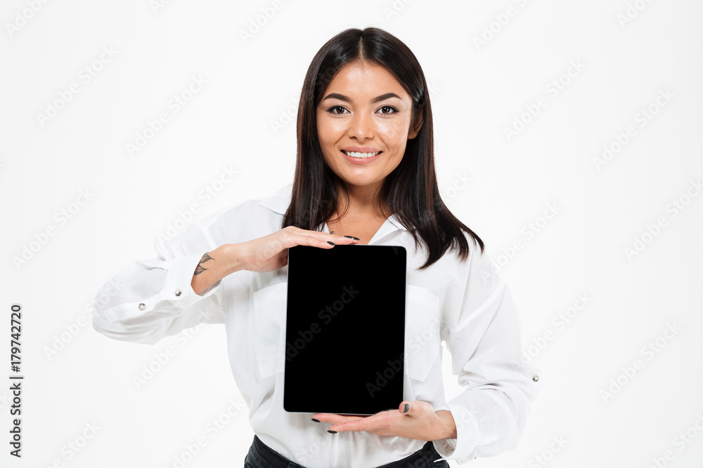 Cheerful young asian lady showing display of tablet computer Cheerful young asian lady showing display of tablet computer