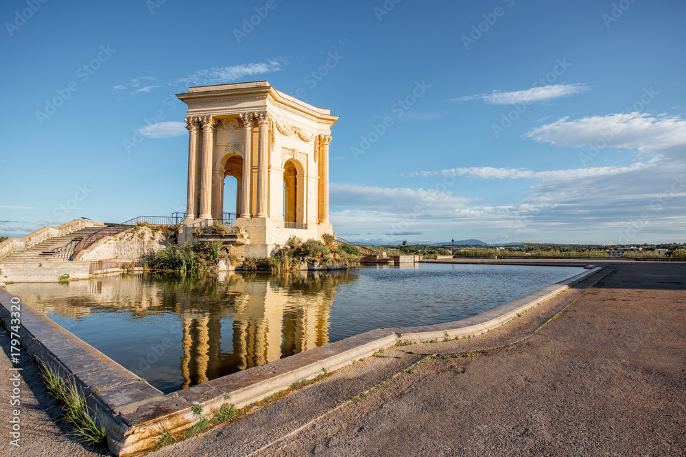 View on the water tower in Peyrou garden with beautiful water reflection during the morning light in Montpellier city in southern France