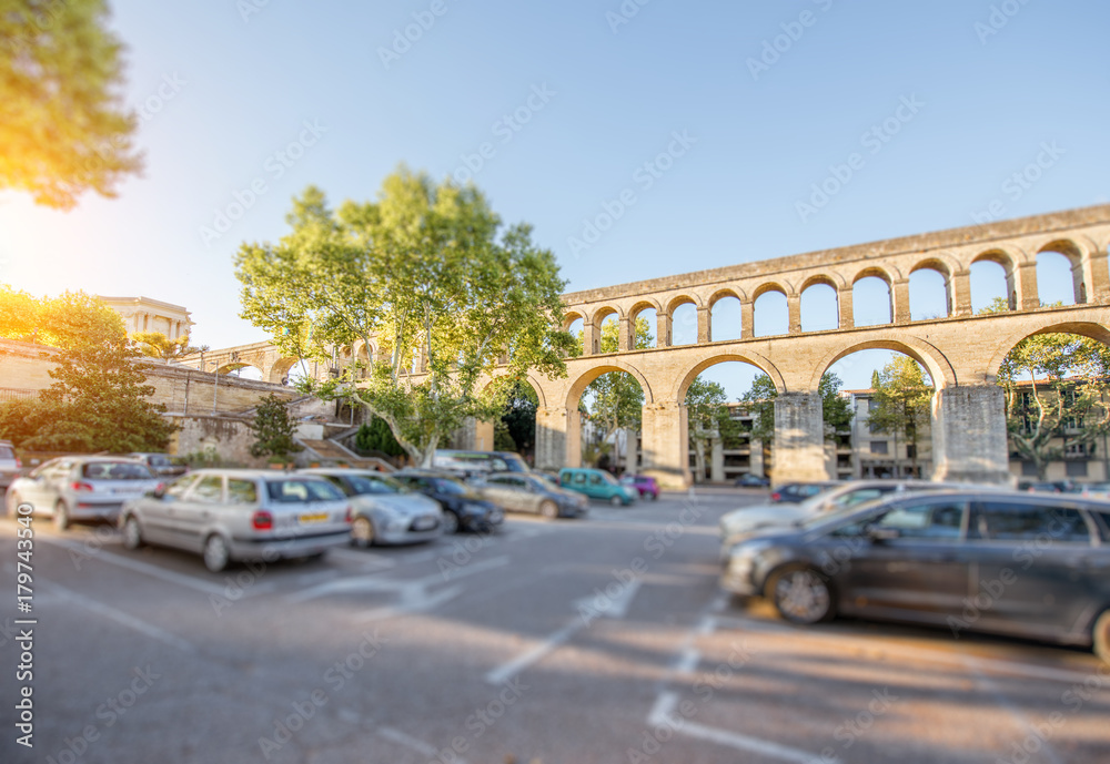 View on the saint Clement aqueduct in Peyrou garden during the morning light in Montpellier city in southern France. Tilt-shift image technic with blurred cars