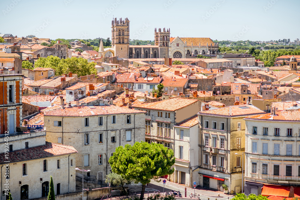 Fototapeta premium Aerial cityscape view on the old town with cathedral in Montpellier city during the sunny weather in Occitanie region of France