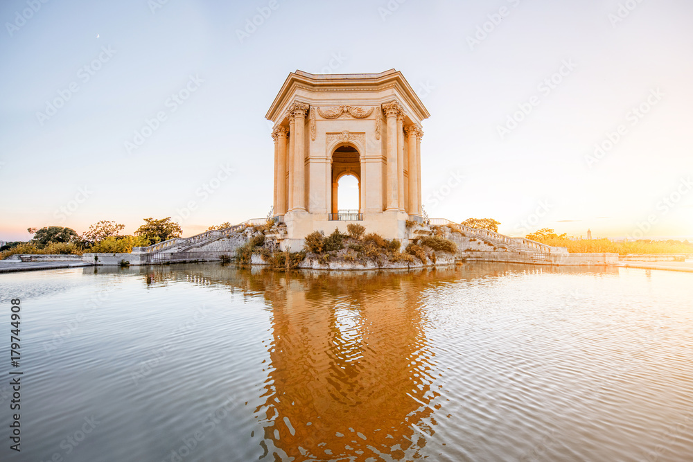 View on the water tower in Peyrou garden with beautiful water reflection during the evening light in Montpellier city in southern France View on the water tower in Peyrou garden with beautiful water reflection during the evening light in Montpellier city in southern France