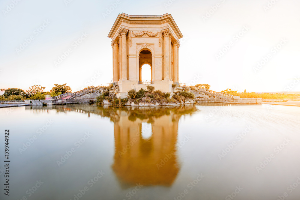 View on the water tower in Peyrou garden with beautiful water reflection during the evening light in Montpellier city in southern France View on the water tower in Peyrou garden with beautiful water reflection during the evening light in Montpellier city in southern France