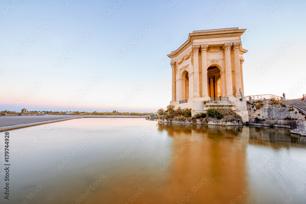 View on the water tower in Peyrou garden with beautiful water reflection during the evening light in Montpellier city in southern France