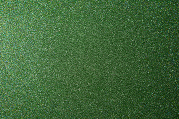 texture of green glitter paper background for design Christmas or New Year's cards