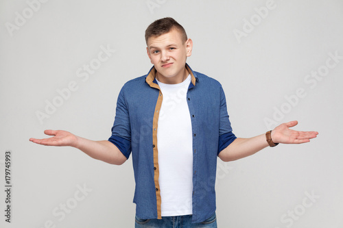 Confused young man looking at camera.