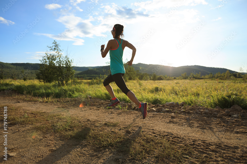 young trail runner woman running on sunset forest young trail runner woman running on sunset forest