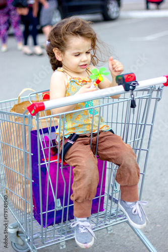 Little kid girl sitting in ...