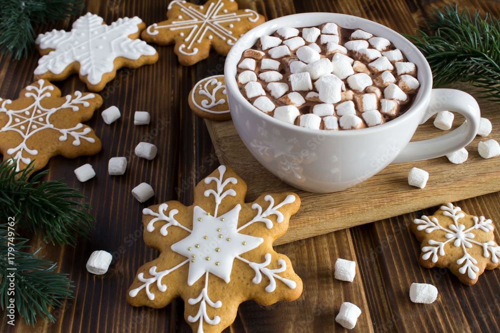 Hot chocolate with marshmallows and Christmas cookies on the wooden background Hot chocolate with marshmallows and Christmas cookies on the wooden background