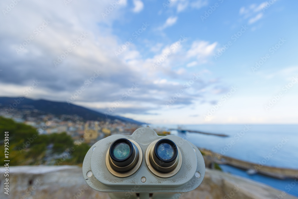 An old binoculars pointing on the city