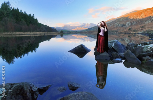 Wallpaper Mural Woman with long red hair reflected in still lake