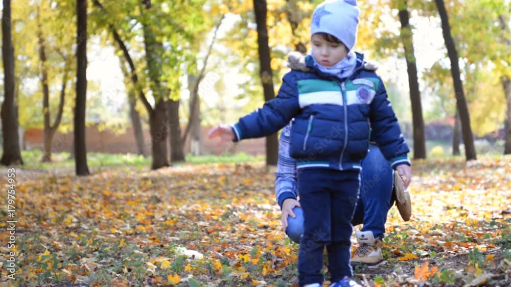 Mom and his little son are playing in the park. Mom and his little son are playing in the park.