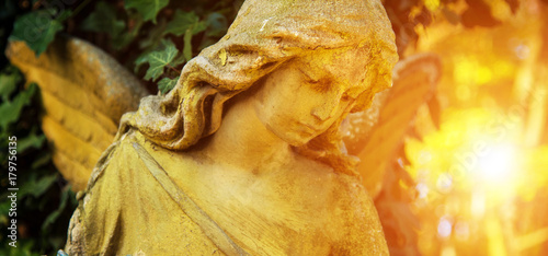 Obraz na płótnie The figure of an angel in a golden glow. Symbol of love, invisible forces, purity, enlightenment, ministry. Guard. Place for the inscription. w salonie