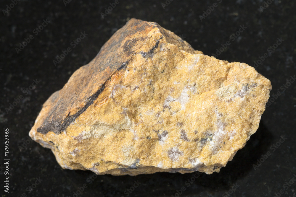 raw Narsarsukite stone on dark background
