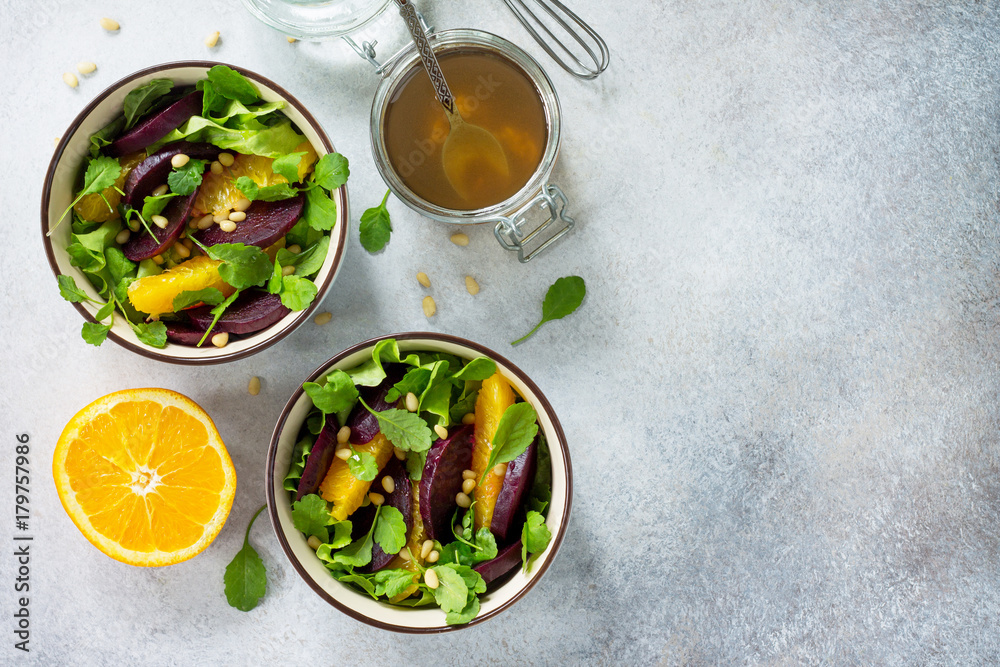 Homemade snacks on a gray stone or slate background. Salad with beets, orange, arugula and pine nuts. Top view with copy space. Homemade snacks on a gray stone or slate background. Salad with beets, orange, arugula and pine nuts. Top view with copy space.