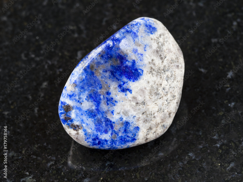tumbled lazurite stone on dark background tumbled lazurite stone on dark background