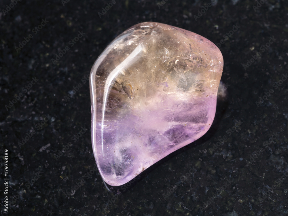 tumbled Ametrine gemstone on dark background tumbled Ametrine gemstone on dark background