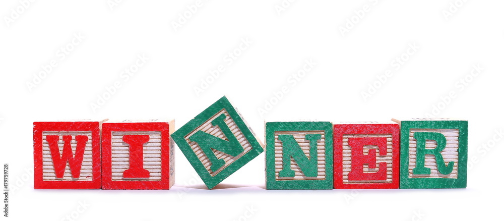 Alphabet blocks, letters spelling out word winner isolated on white background
