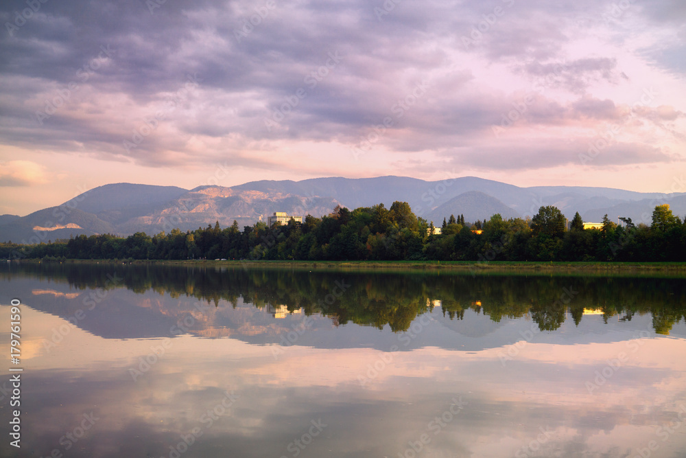 Colorful sunset on the lake with reflections of hills, trees and buildings. Slovakia Colorful sunset on the lake with reflections of hills, trees and buildings. Slovakia