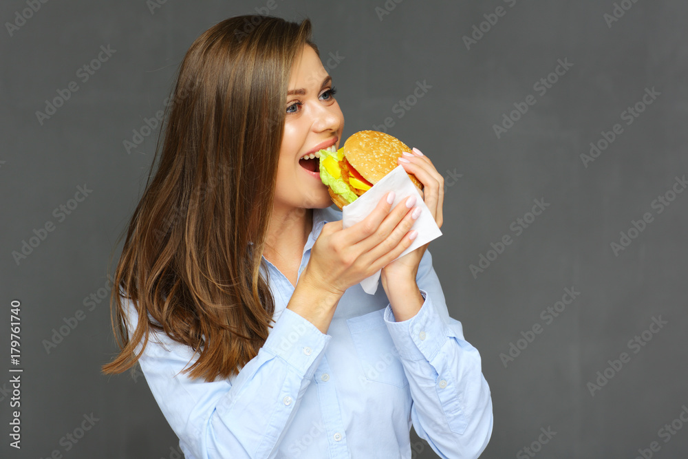 woman eating burger use paper tissue. woman eating burger use paper tissue.