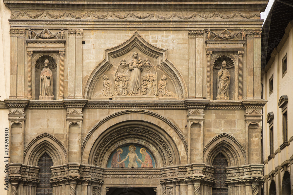 Sculptured religious artwork Front of the Church in Arezzo, Tuscany, Italy