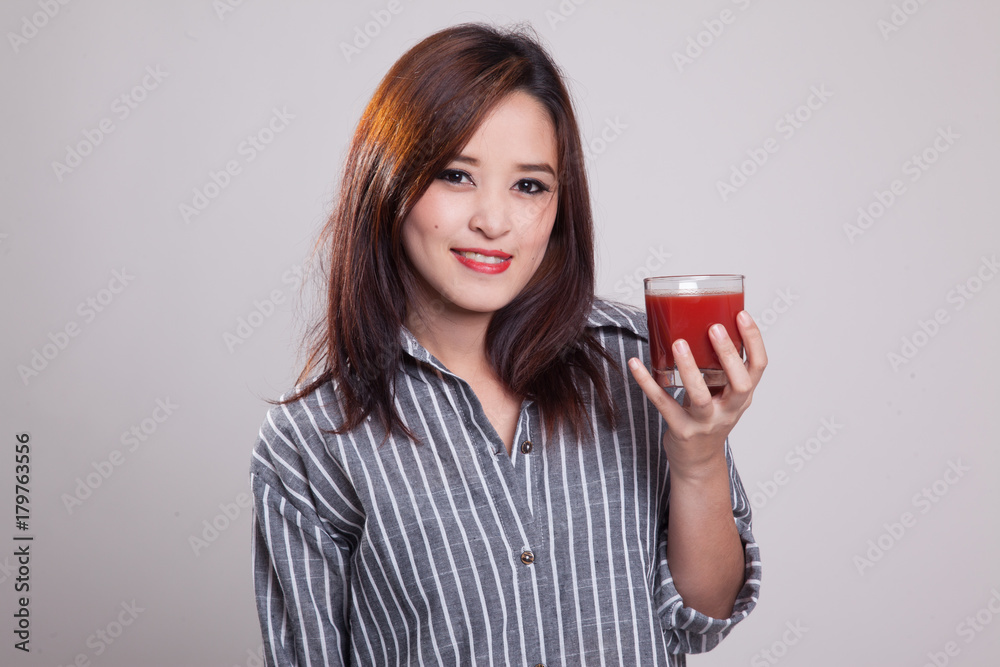 Young Asian woman drink tomato juice. Young Asian woman drink tomato juice.