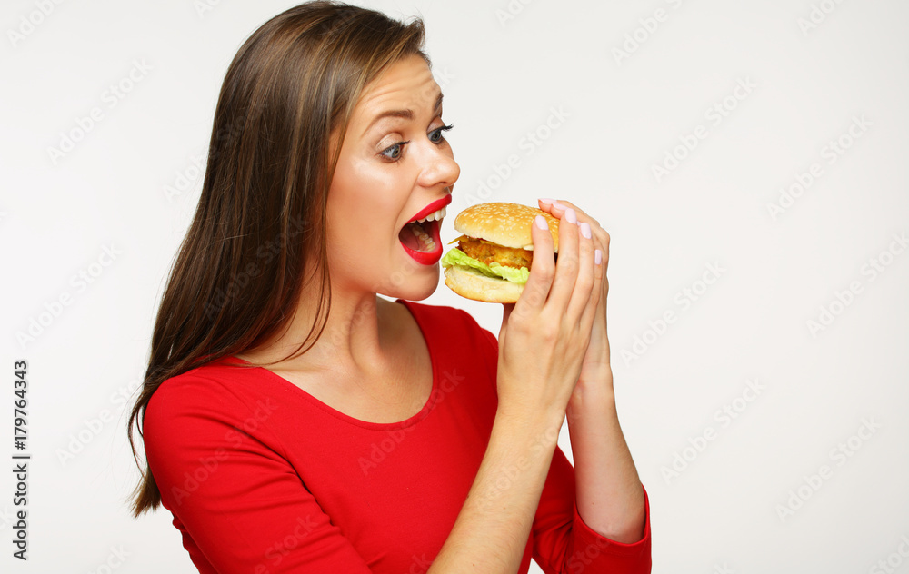 Woman eating burger. Isolated portrait on white Woman eating burger. Isolated portrait on white