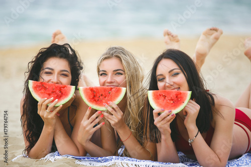 A group of beautiful young girls on the beach tanning © olenachukhil