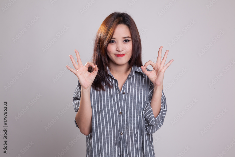 Asian woman show double OK hand sign  and smile.
