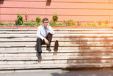 Portrait of a Business man being bored sitting on stairs