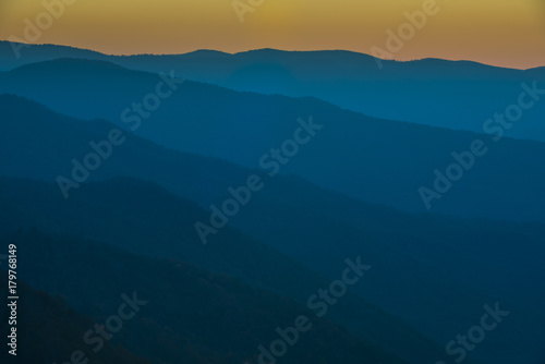 Glorious Sunrise over the Great Smoky Mountains layered blue ridges to the orange yellow horizon © Condor 36