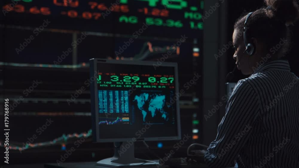 Sad woman stock broker working in futuristic office with live global market feed displays. Sad woman stock broker working in futuristic office with live global market feed displays.