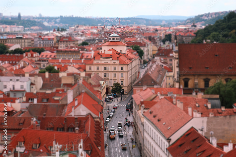 Panorama of Prague red roofs, people and cars on the street