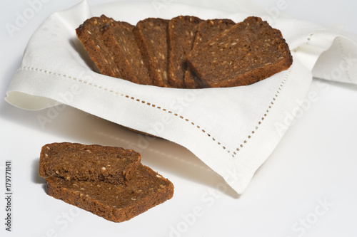 Several pieces of rye bread on white napkin