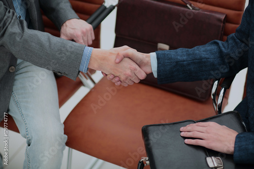 businessman shaking hands to seal a deal with his partner