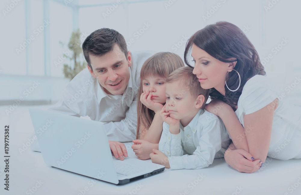 family looking into the laptop enthusiastically family looking into the laptop enthusiastically