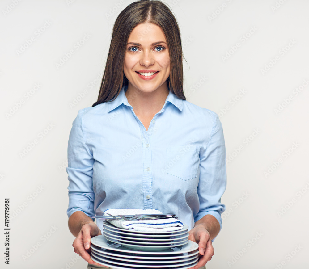 Smiling woman holding dishes plates table set. Smiling woman holding dishes plates table set.