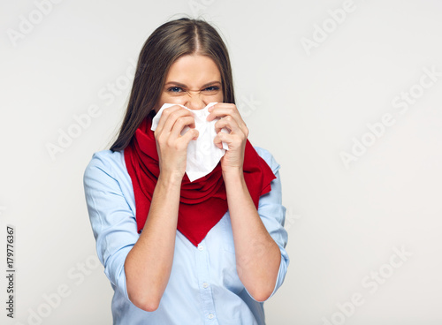 Sickness woman blowing his nose in paper tissue.