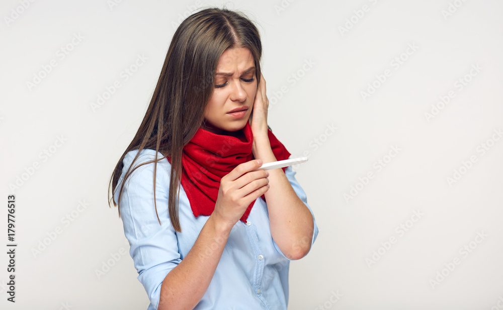 Sick woman looking on thermometer.