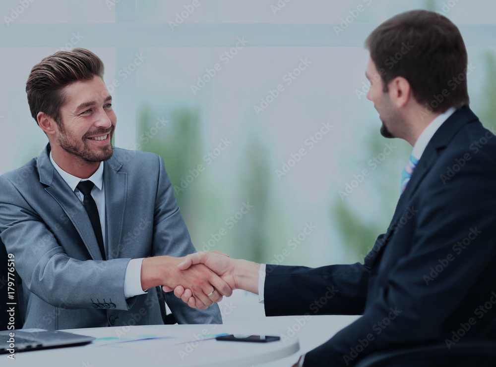 Two business colleagues shaking hands during meeting Two business colleagues shaking hands during meeting