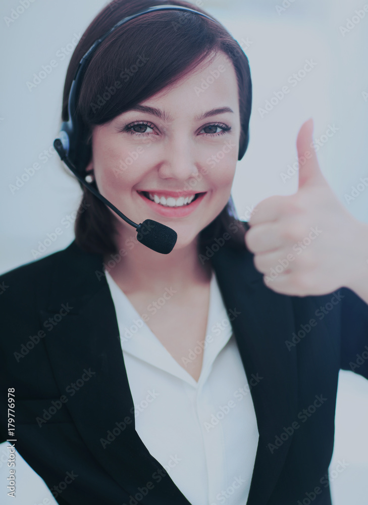 Beautiful woman working at callcenter, using headset showing thu Beautiful woman working at callcenter, using headset showing thu