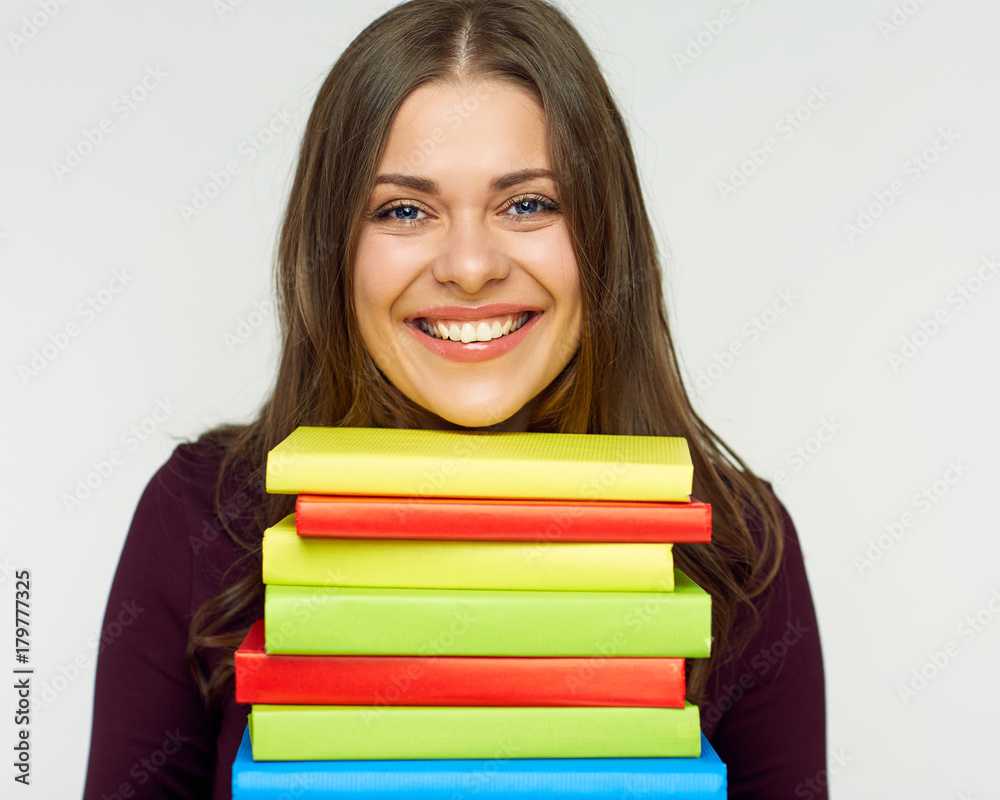smiling student girl holding pile, stack of books. smiling student girl holding pile, stack of books.