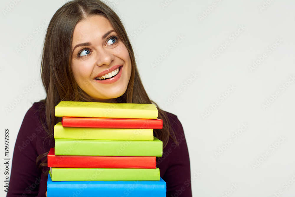 smiling student girl holding pile, stack of books. smiling student girl holding pile, stack of books.