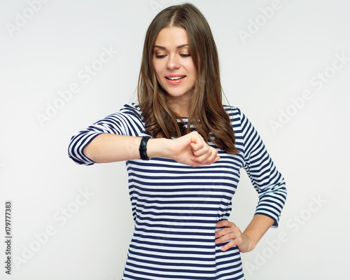 Smiling woman looking at watch. © Yuriy Shevtsov