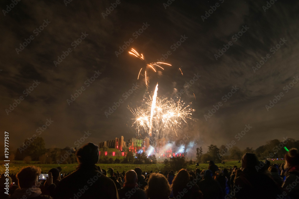 People watching Fireworks display at bonfire 4th of November celebration, Kenilworth Castle, united kingdom.