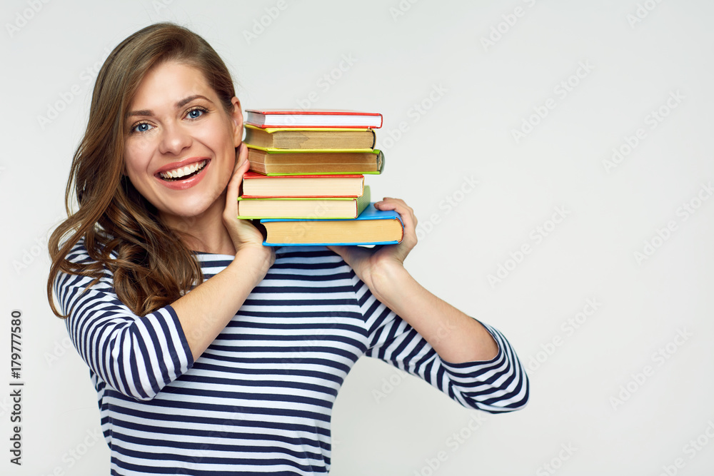 Smiling woman holding book pile. Smiling woman holding book pile.