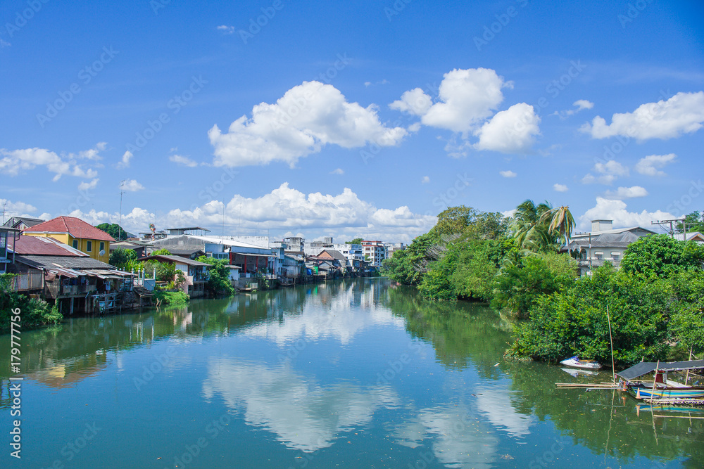 Beautiful landscape view of waterfront home or old town located beside the river with blue sky in the background at countryside of Chanthaburi Province, Thailand.