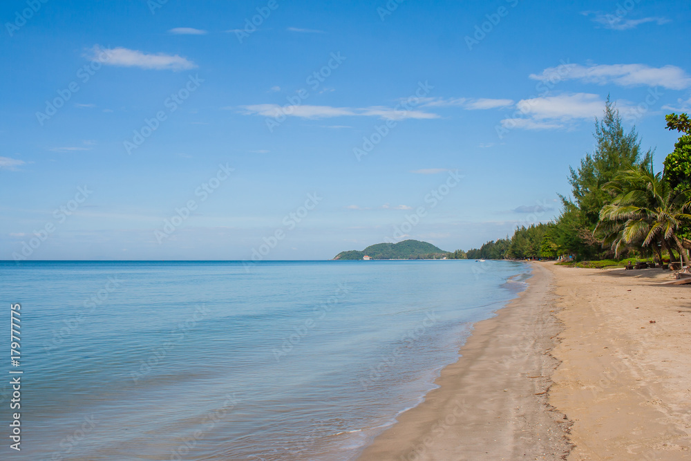Beautiful seascape view of sand beach with sea and island in the background at summer time. (Selective focus)
